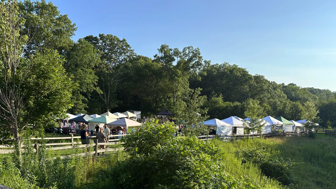 Vendor tents set up in the field at Tilted Barn Brewery